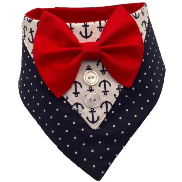 The Sailor Tux Bandana boasts a nautical design with anchor patterns and polka dots, enhanced by a red bow tie and two decorative buttons for a formal and charming look.