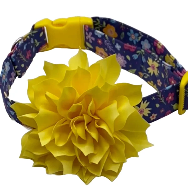 The Yellow Blossom Dog Collar features a vibrant yellow fabric flower, a colorful floral pattern, and is secured with a yellow buckle.