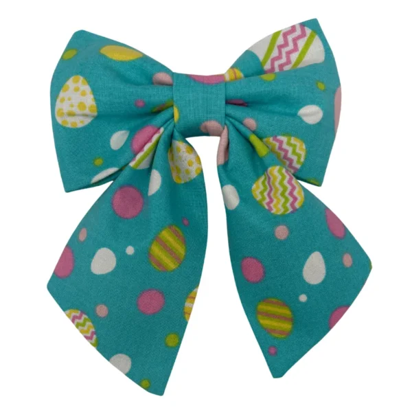 The Eggstra Fancy Sailor Pet Bowtie showcases a teal bow with two tails, featuring colorful Easter egg patterns and pink, yellow, and white polka dots.