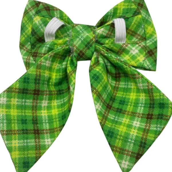 The Irish Plaid Sailor Bowtie for Little Dogs and Cats features a charming plaid pattern in green, yellow, white, and brown stripes, with long pointed tails and looped design secured by a white elastic band.